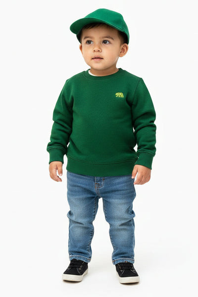Child wearing a green sweatshirt and cap on a white background