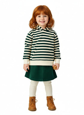 Child wearing a striped dress with a green skirt on a white background